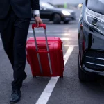Luxury black limo waiting outside Houston airport terminal with chauffeur
