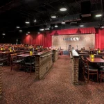 Houston Improv Club entrance at night with people entering