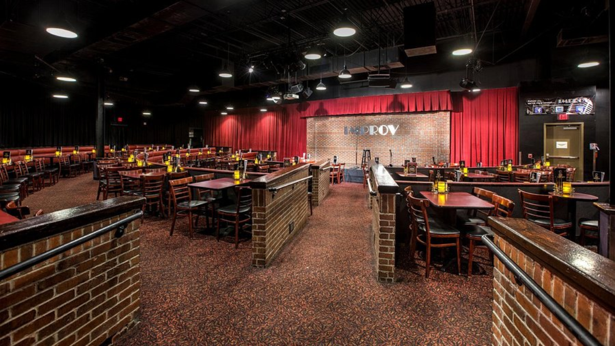 Houston Improv Club entrance at night with people entering